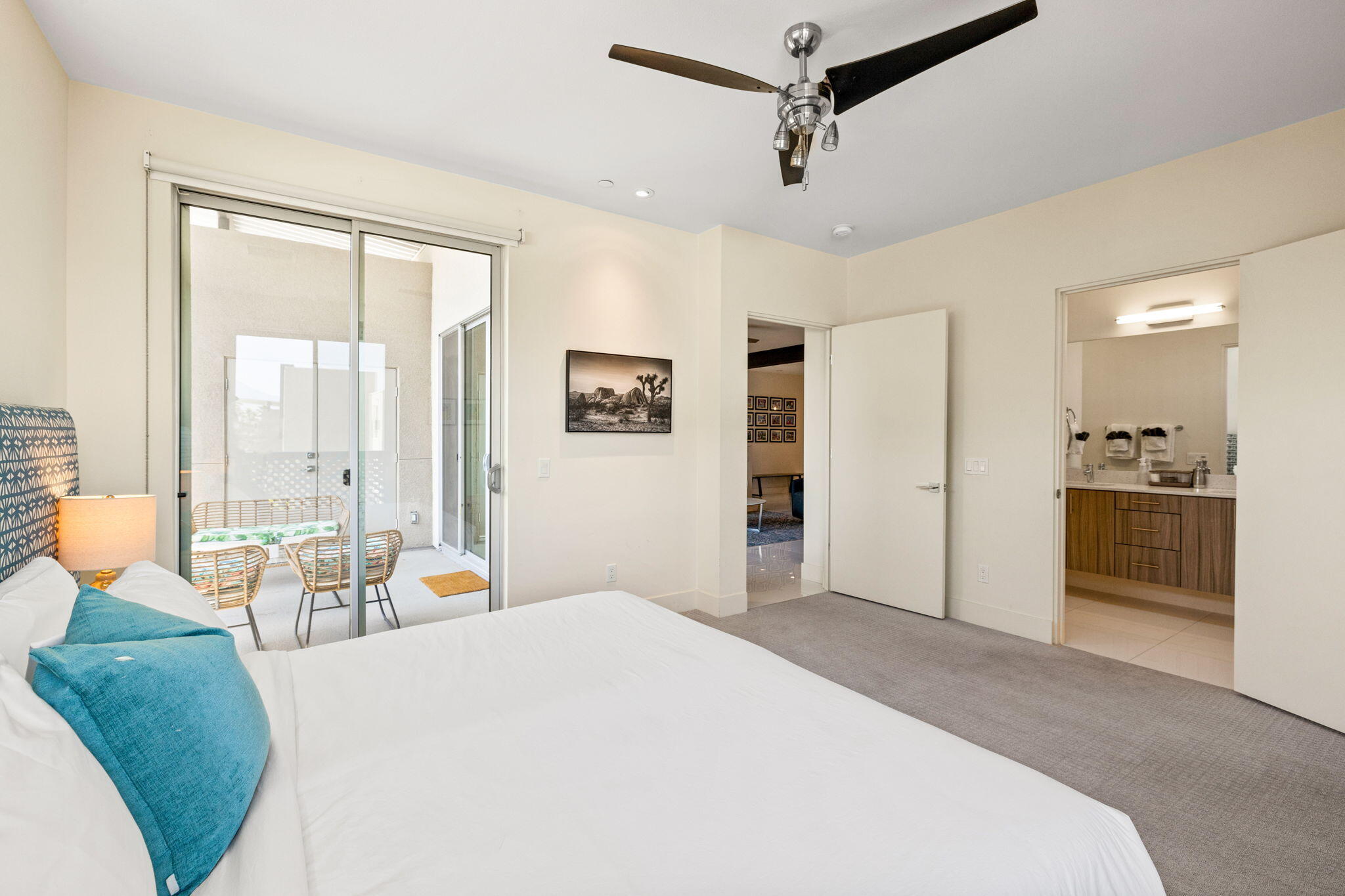 191 The River Palm Springs, CA 92262 - Photo 26 of 39 a bedroom with a bed large window and couch