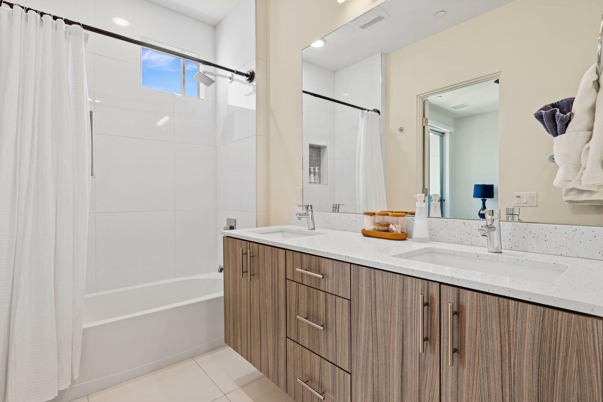 191 The River Palm Springs, CA 92262 - Photo 33 of 39 a bathroom with a double vanity sink a mirror a bathtub and shower