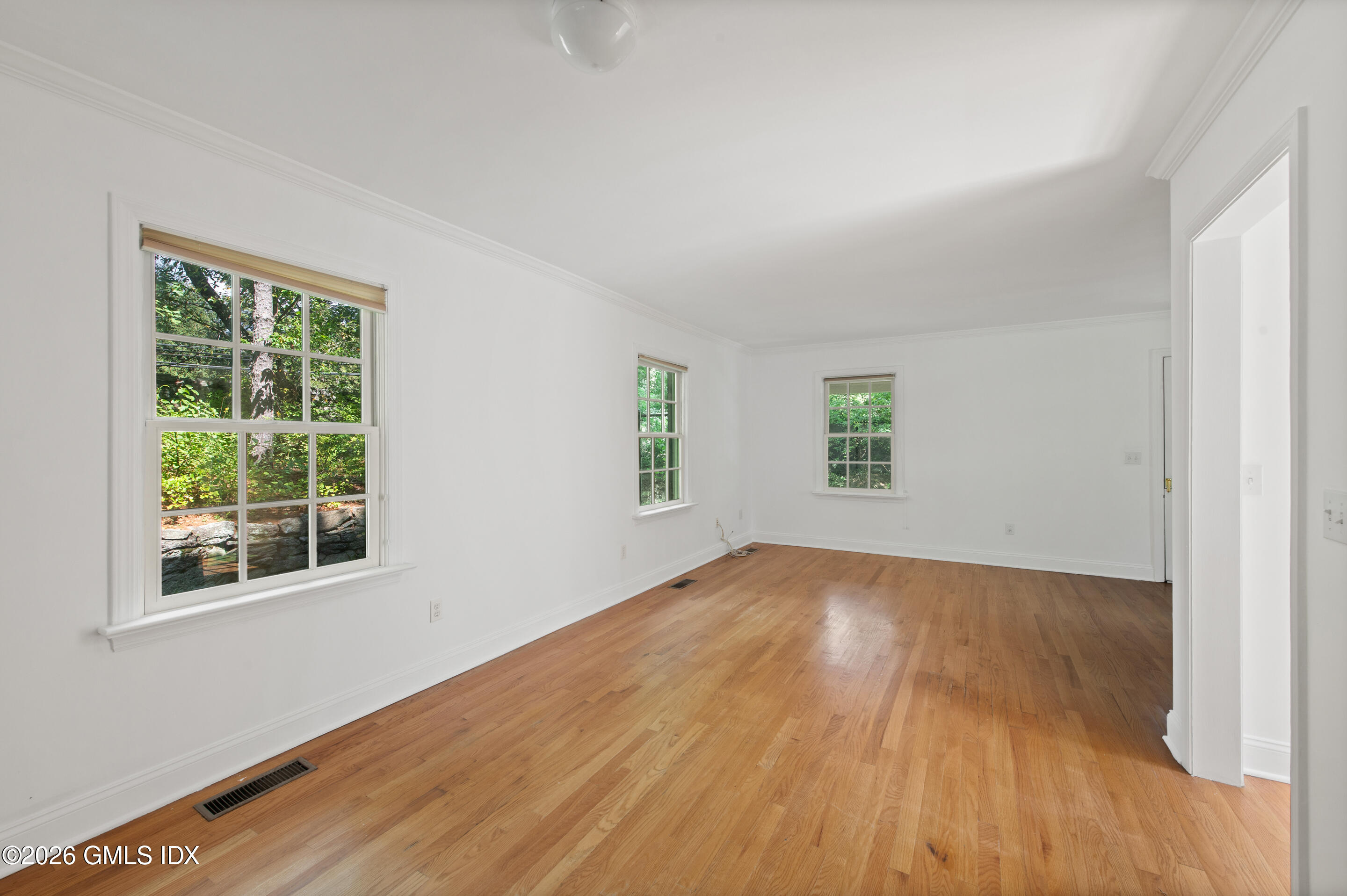122 Round Hill Road Greenwich, CT 06831 - Photo 29 of 37 an empty room with wooden floor and windows