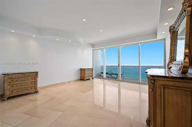 an empty room with a cabinet and mirrors