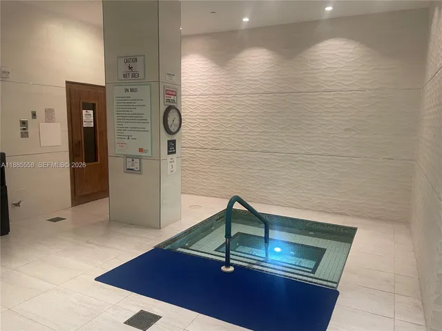 a swimming pool with outdoor seating and plants