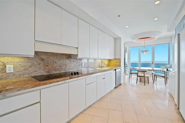 a kitchen with sink and cabinets
