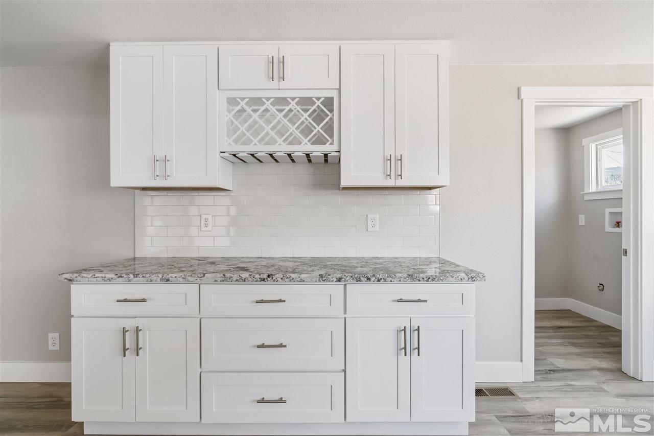 4125 Warren Way Reno, NV 89509 - Photo 8 of 25 a kitchen with white cabinets and a sink