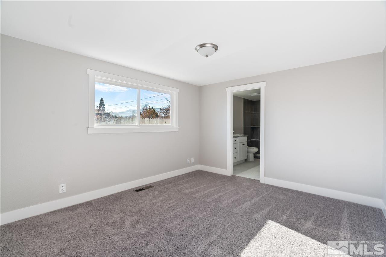 4125 Warren Way Reno, NV 89509 - Photo 9 of 25 an empty room with windows and closet