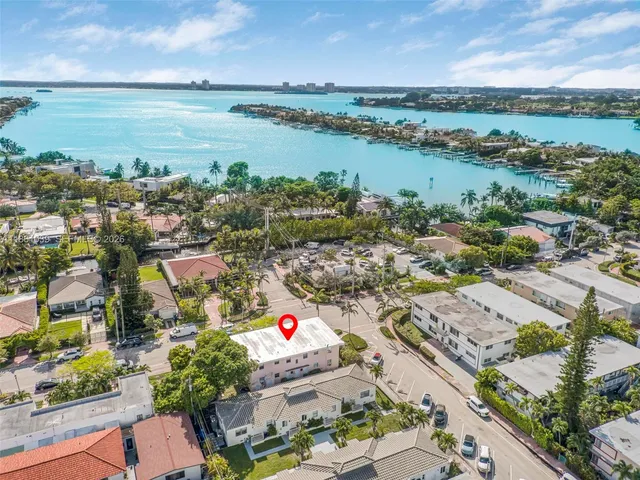 an aerial view of lake and residential houses with outdoor space