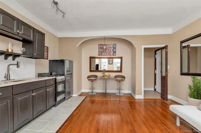 a kitchen with a sink and wooden floor
