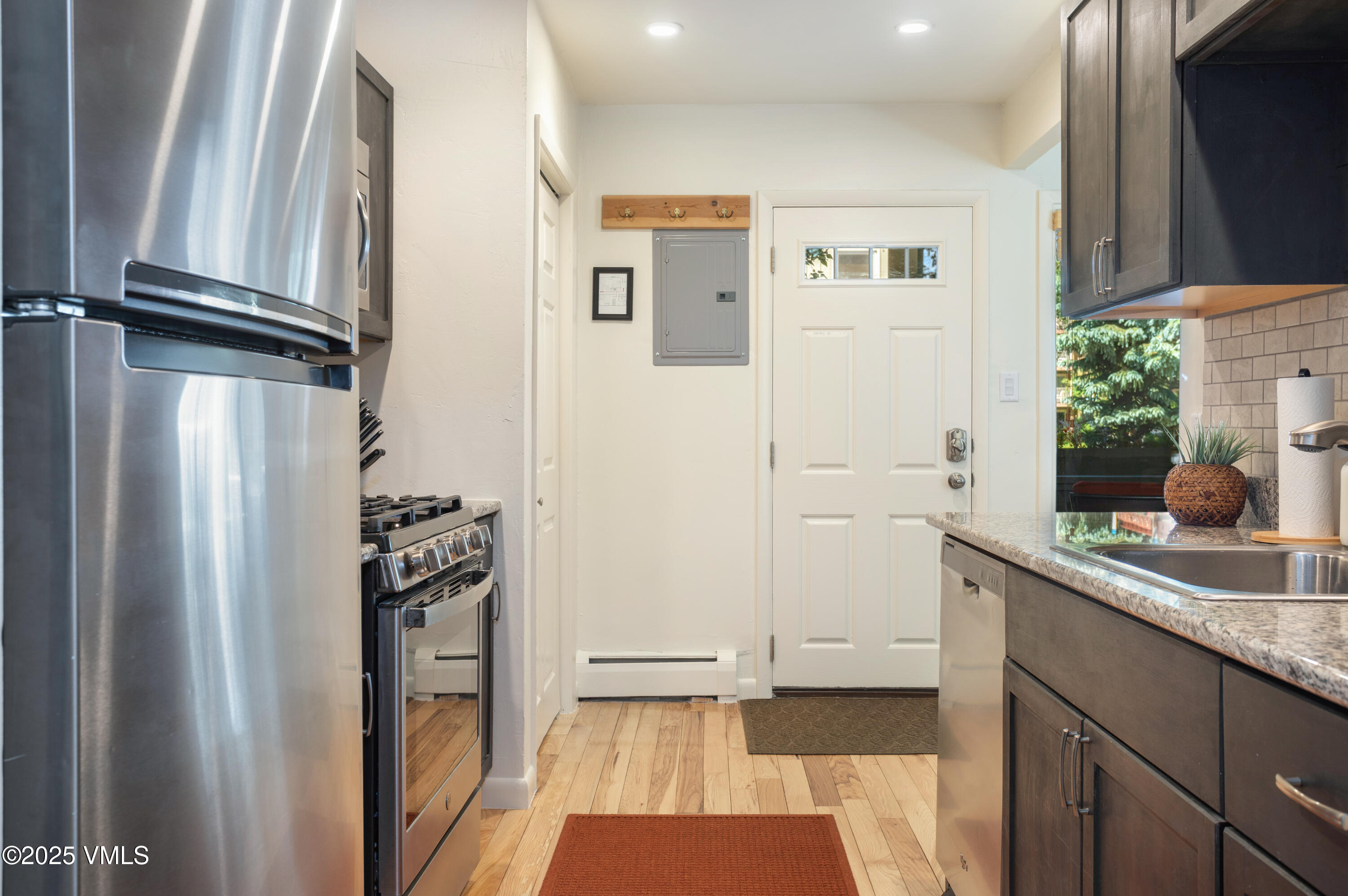909 Red Sandstone Road, Unit B2 Vail, CO 81657 - Photo 13 of 24 a kitchen with white cabinets and refrigerator