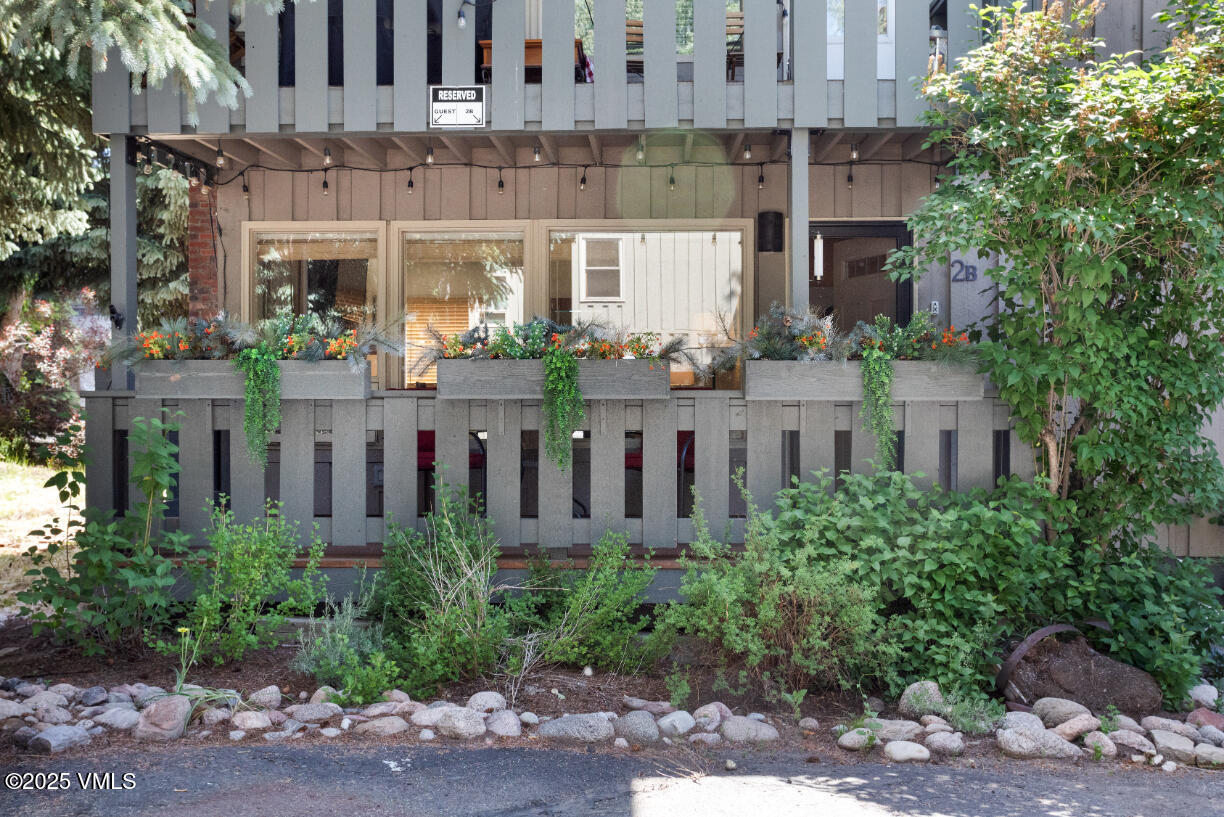 909 Red Sandstone Road, Unit B2 Vail, CO 81657 - Photo 21 of 24 a front view of a building with plants