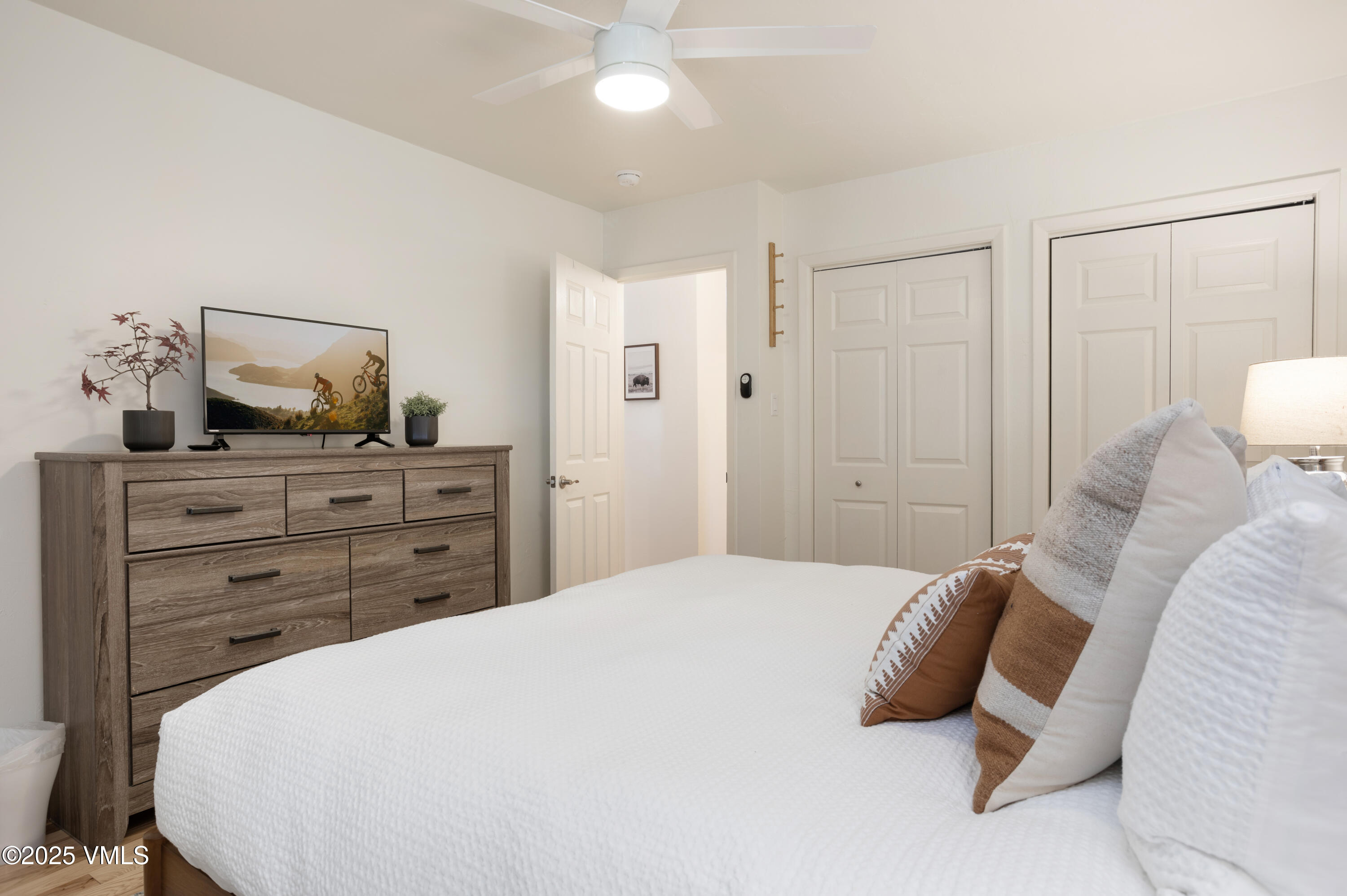 909 Red Sandstone Road, Unit B2 Vail, CO 81657 - Photo 6 of 24 a bedroom with a bed and cabinet