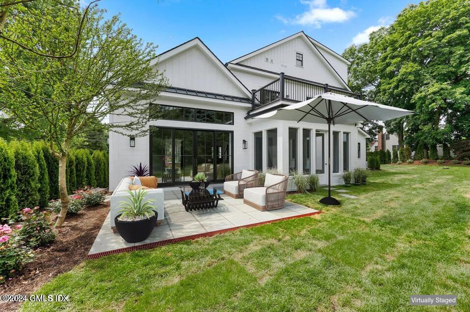 97 Lockwood Road Riverside, CT 06878 - Photo 14 of 59 a view of a house with backyard sitting area and garden