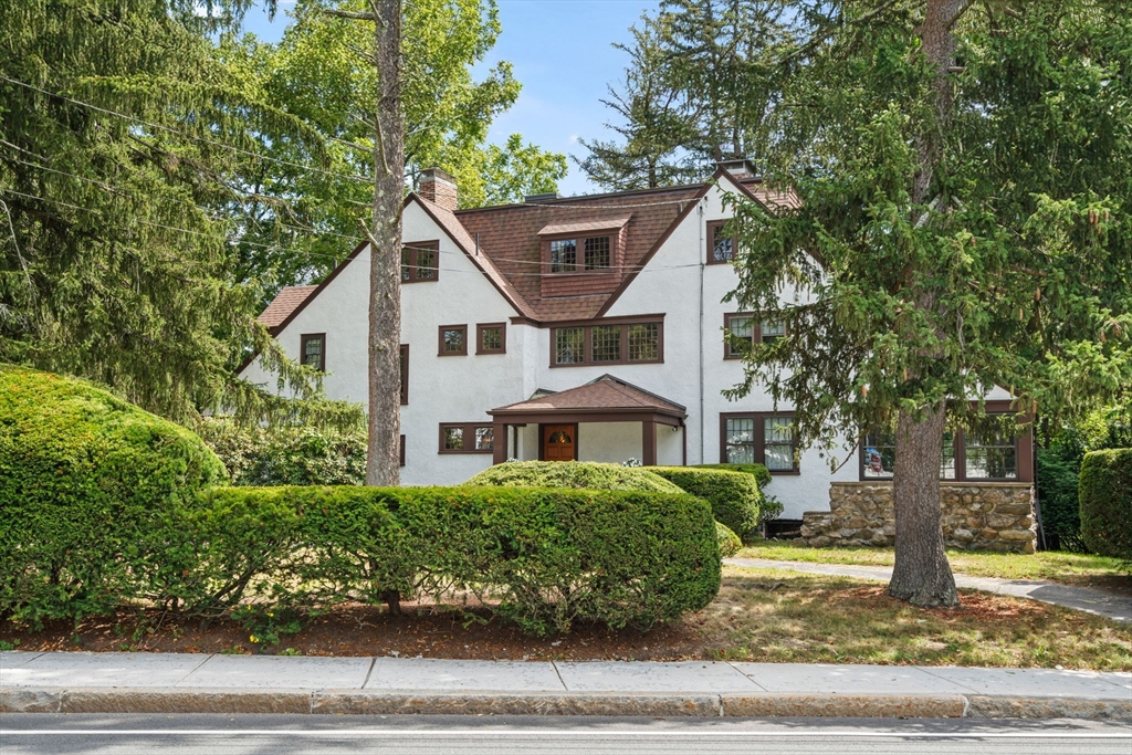 a front view of a house with a garden