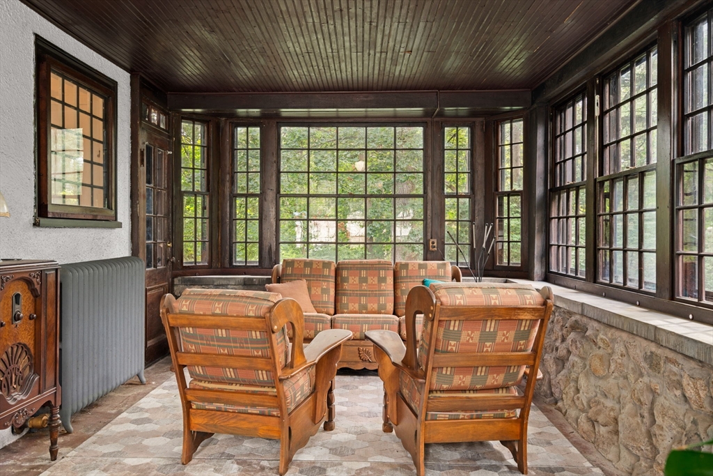 570 Washington Street Dedham, MA 02026 - Photo 21 of 37 a living room with furniture a large window and a chandelier