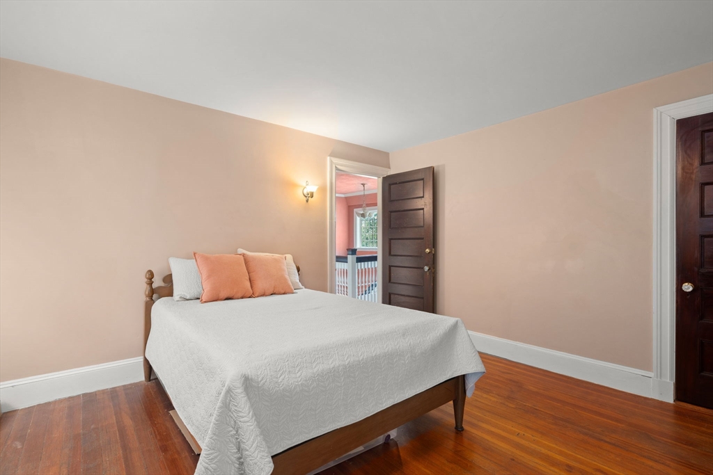 570 Washington Street Dedham, MA 02026 - Photo 31 of 37 a large bedroom with a bed and wooden floor