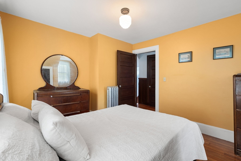 570 Washington Street Dedham, MA 02026 - Photo 34 of 37 a bedroom with a bed and a table