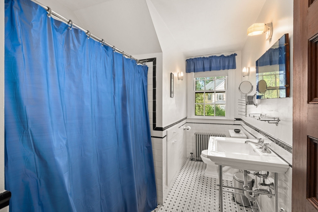 570 Washington Street Dedham, MA 02026 - Photo 36 of 37 a bathroom with a sink toilet and shower