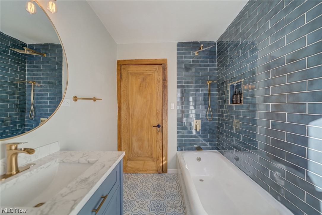 6197 Turney Road Cleveland, OH 44125 - Photo 13 of 35 Bathroom with tiled shower / bath, vanity, and tile flooring