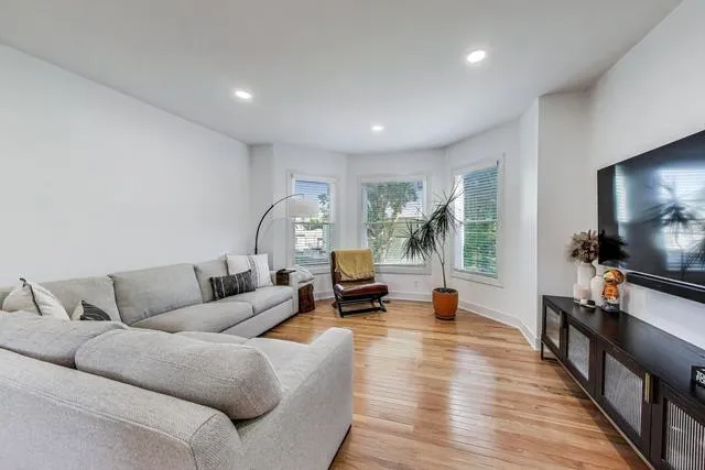 a living room with furniture and a flat screen tv