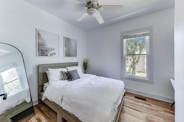 a bedroom with a large bed and a window
