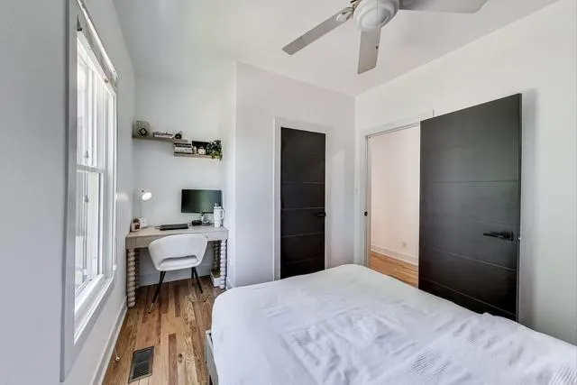 a bedroom with a bed and a desk