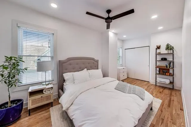 a bedroom with a bed and a potted plant