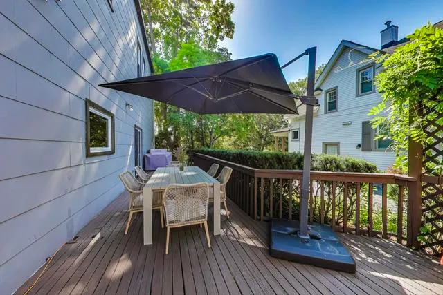 a view of a deck with table and chairs under an umbrella