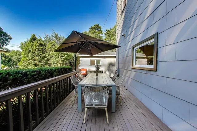a view of a chairs and table on the balcony