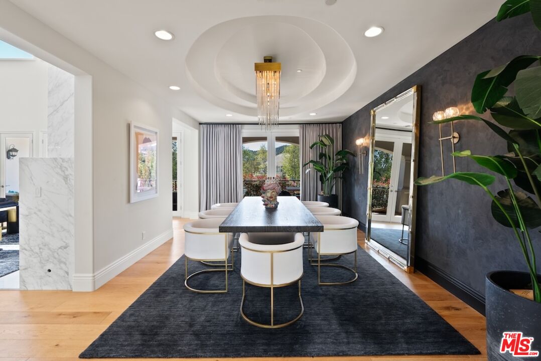 23593 Parksouth Street Calabasas, CA 91302 - Photo 12 of 75 a dining room with furniture a chandelier and wooden floor
