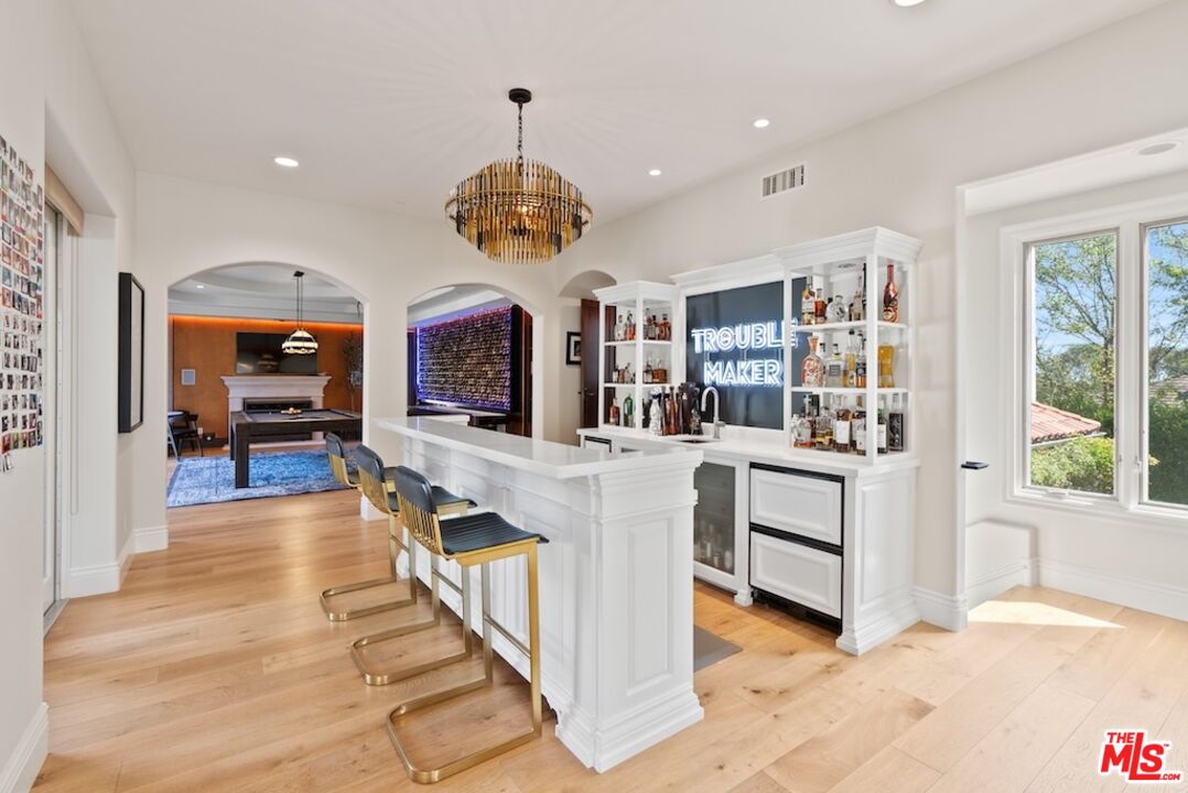 23593 Parksouth Street Calabasas, CA 91302 - Photo 16 of 75 a view of living room kitchen with stainless steel appliances kitchen island granite countertop furniture and a view of living room