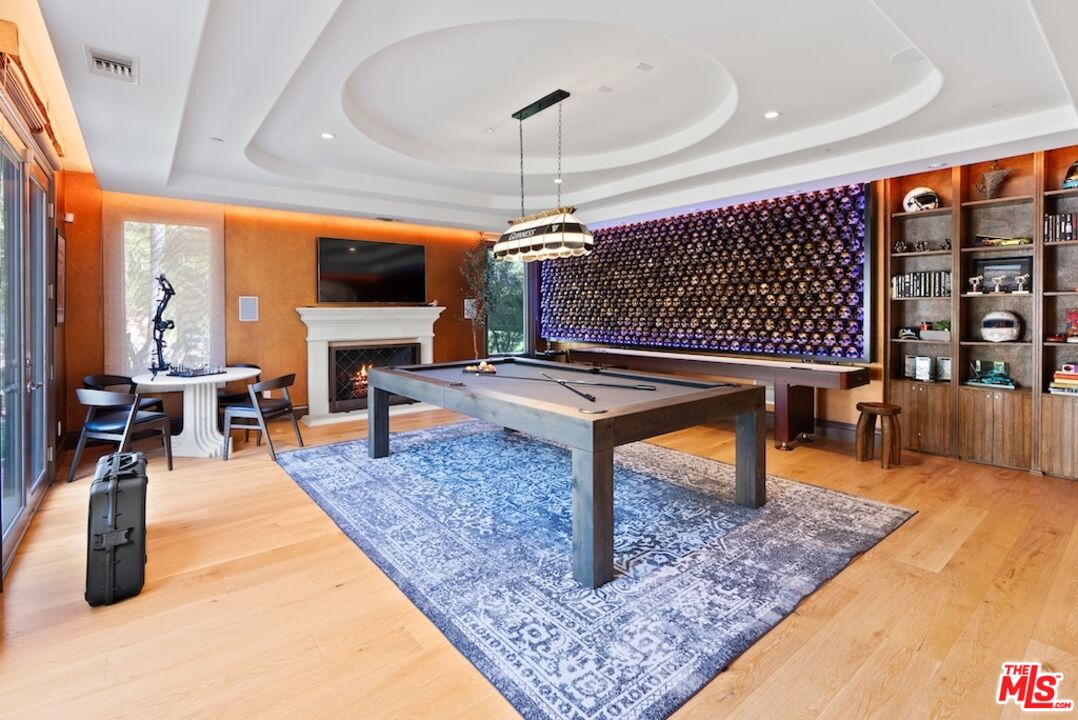 23593 Parksouth Street Calabasas, CA 91302 - Photo 19 of 75 a living room with furniture a rug and a chandelier