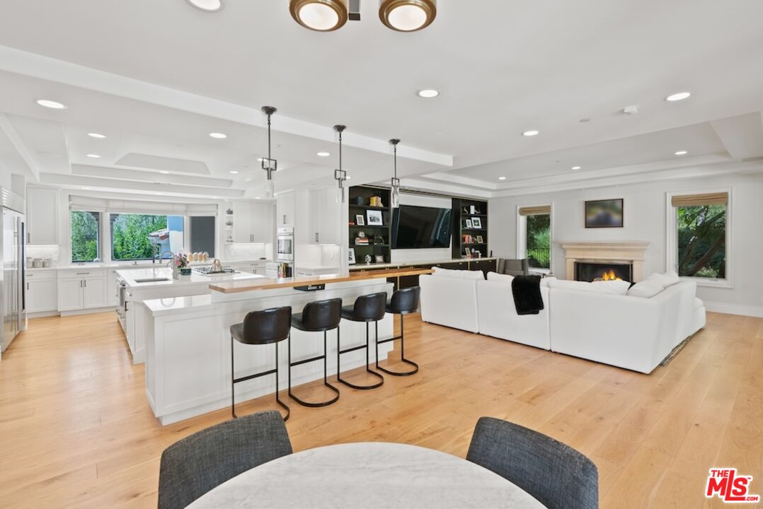 23593 Parksouth Street Calabasas, CA 91302 - Photo 24 of 75 a living room with furniture a flat screen tv and a kitchen view