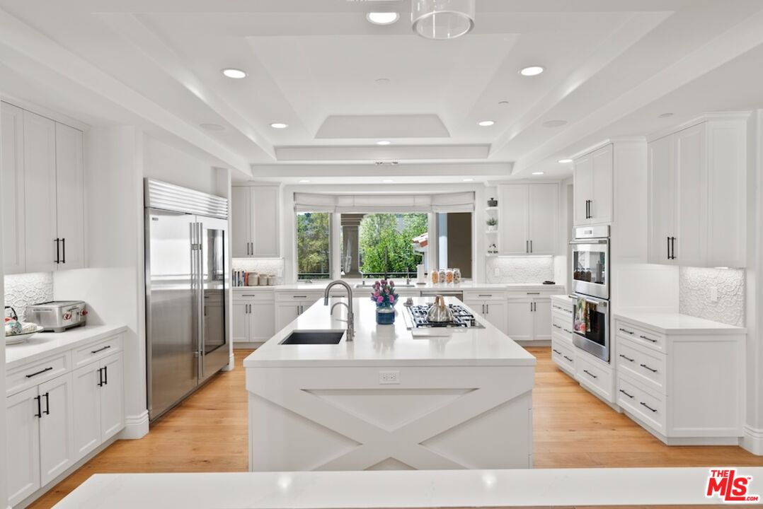 23593 Parksouth Street Calabasas, CA 91302 - Photo 26 of 75 a living room with stainless steel appliances furniture a large window and a view of kitchen