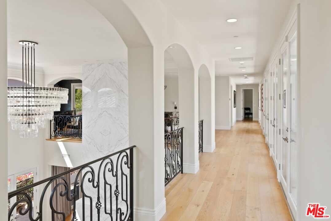 23593 Parksouth Street Calabasas, CA 91302 - Photo 36 of 75 a view of a hallway with wooden floor and staircase
