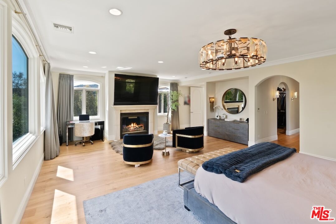 23593 Parksouth Street Calabasas, CA 91302 - Photo 40 of 75 a living room with furniture a flat screen tv and a fireplace