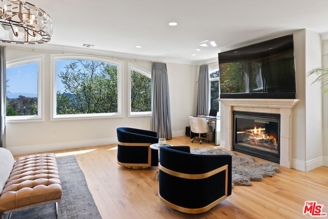 23593 Parksouth Street Calabasas, CA 91302 - Photo 41 of 75 a living room with furniture and a fireplace