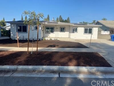 3689 Briscoe Street Riverside, CA 92506 - Photo 1 of 1 a front view of a house with a garden and parking space