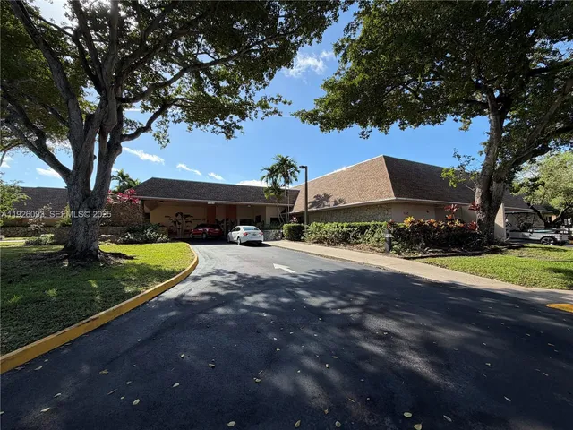 a view of a street with a large trees