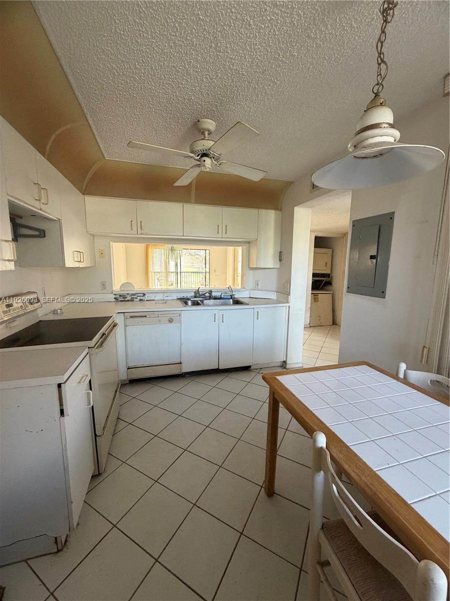 10360 Northwest 30th Court, Unit 204 Sunrise, FL 33322 - Photo 14 of 24 a kitchen with a sink appliances and cabinets