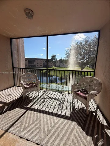 a view of a balcony with two chairs and a table