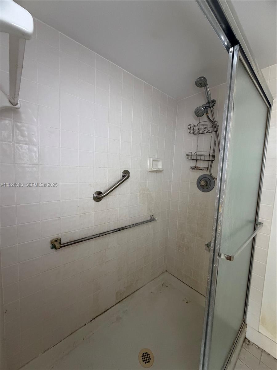 10360 Northwest 30th Court, Unit 204 Sunrise, FL 33322 - Photo 18 of 24 a bathroom with a glass door shower