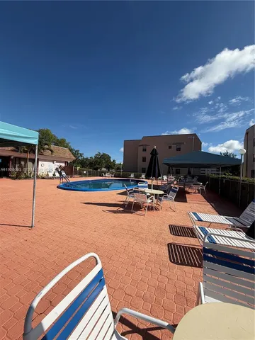 a view of swimming pool with outdoor seating