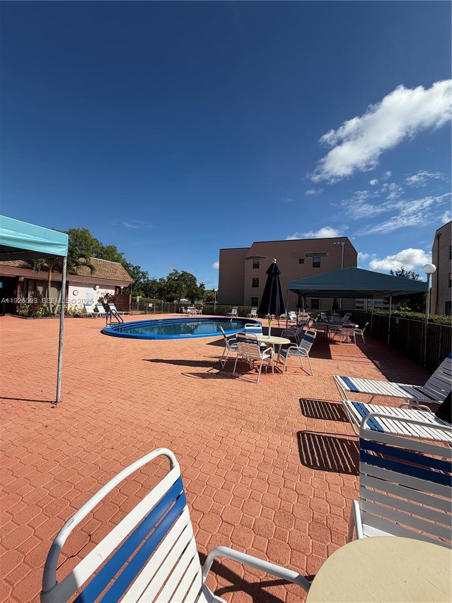 10360 Northwest 30th Court, Unit 204 Sunrise, FL 33322 - Photo 4 of 24 a view of swimming pool with outdoor seating