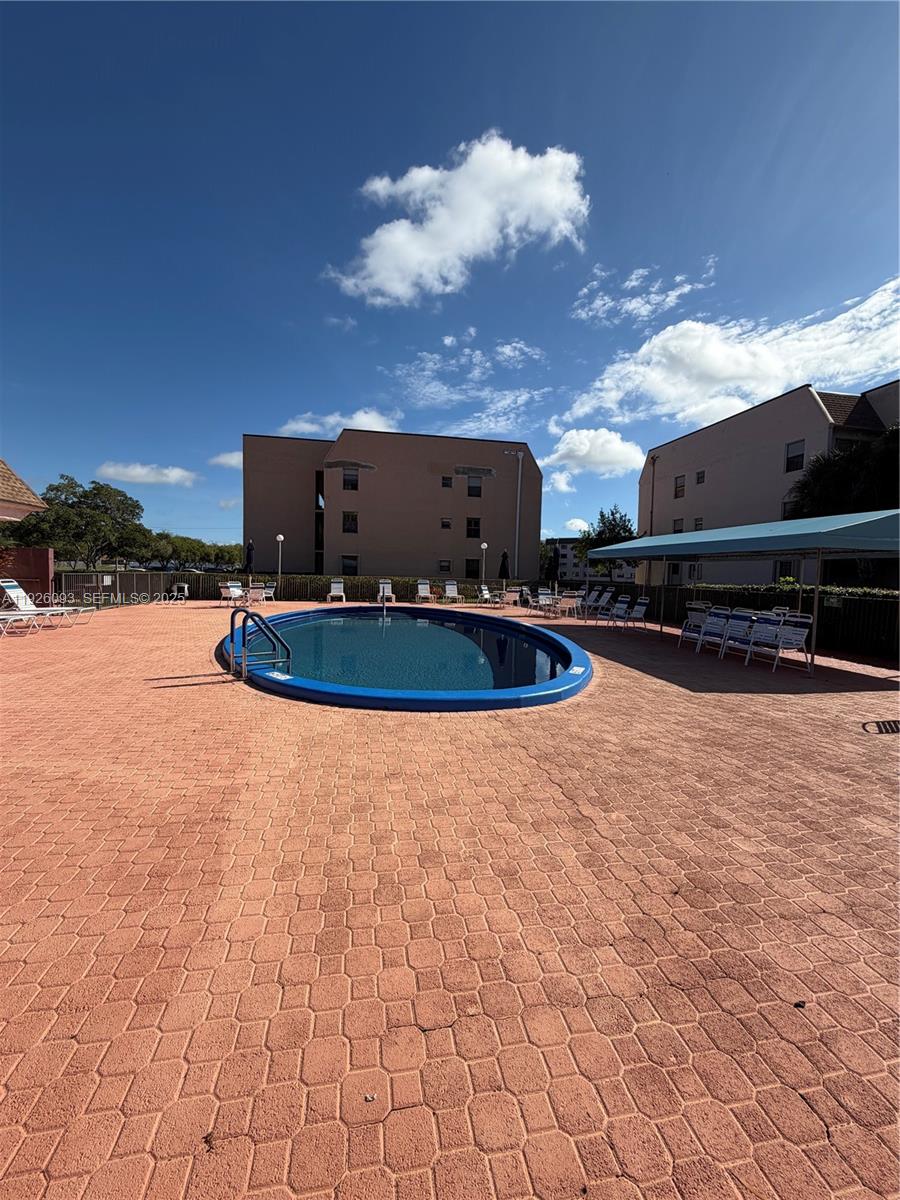 10360 Northwest 30th Court, Unit 204 Sunrise, FL 33322 - Photo 6 of 24 a backyard of a house with table and chairs
