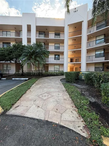 a view of a building with a yard