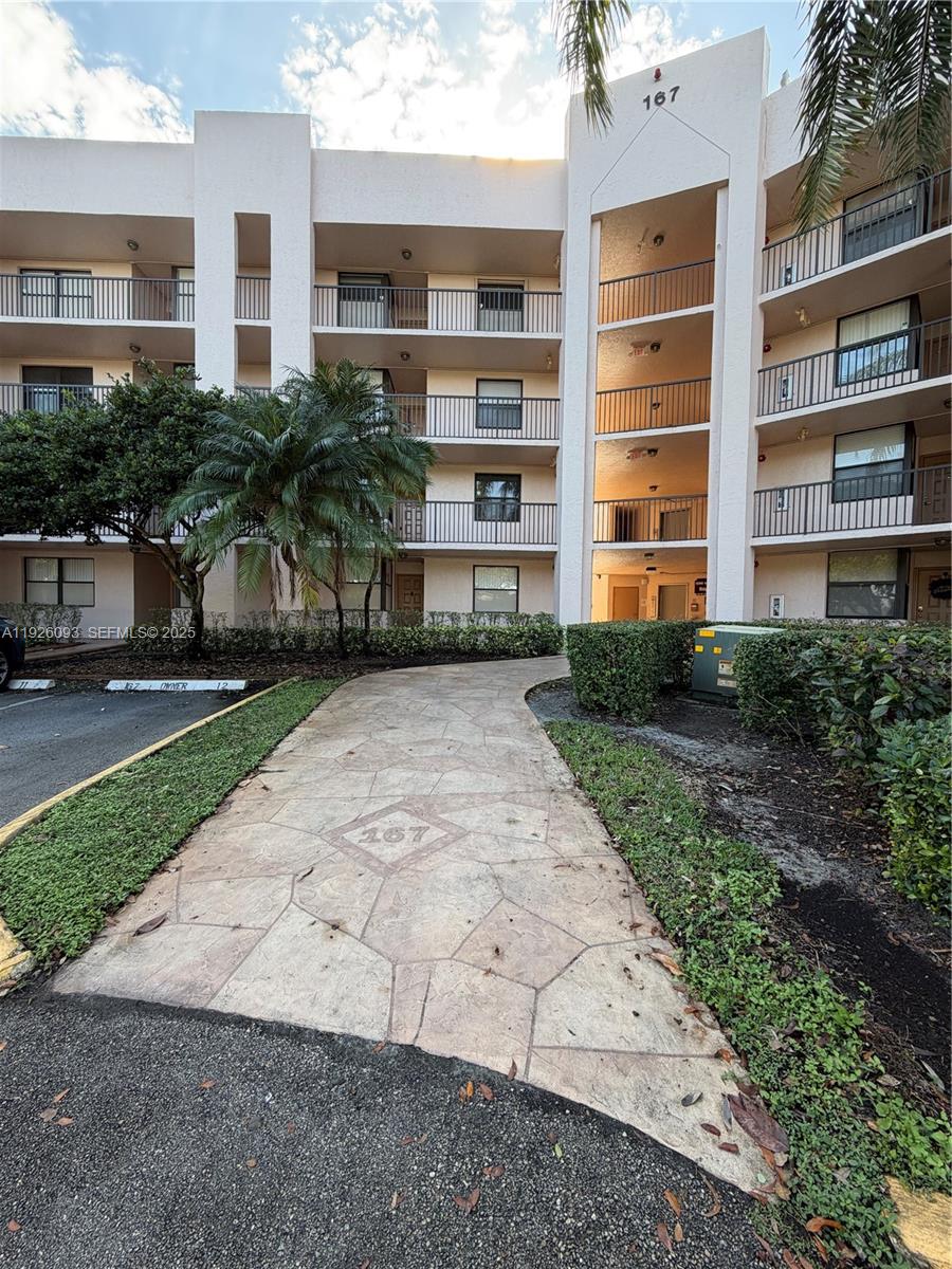 10360 Northwest 30th Court, Unit 204 Sunrise, FL 33322 - Photo 8 of 24 a view of a building with a yard