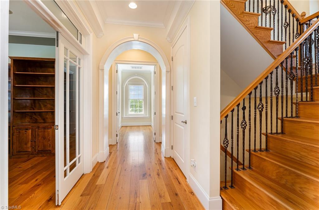 2250 Bethel Church Road Pleasant Garden, NC 27313 - Photo 21 of 45 A private hallway leads to the luxurious primary suite, offering a grand sense of arrival and added seclusion from the rest of the home.