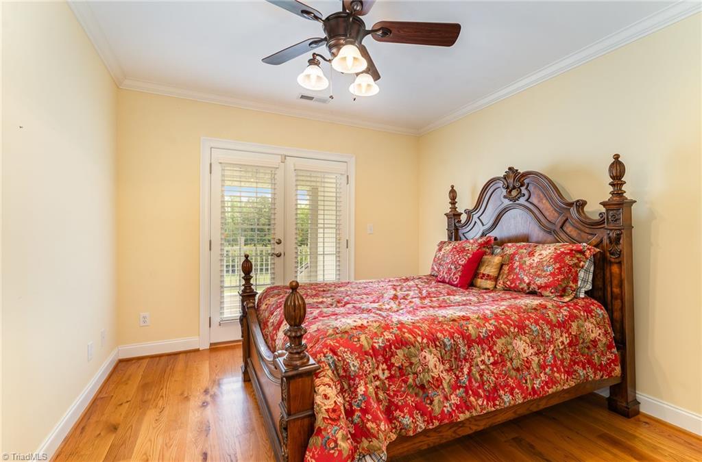2250 Bethel Church Road Pleasant Garden, NC 27313 - Photo 25 of 45 Spacious secondary bedroom featuring a private balcony with scenic views, a full en-suite bathroom, and a walk-in closet for ample storage.