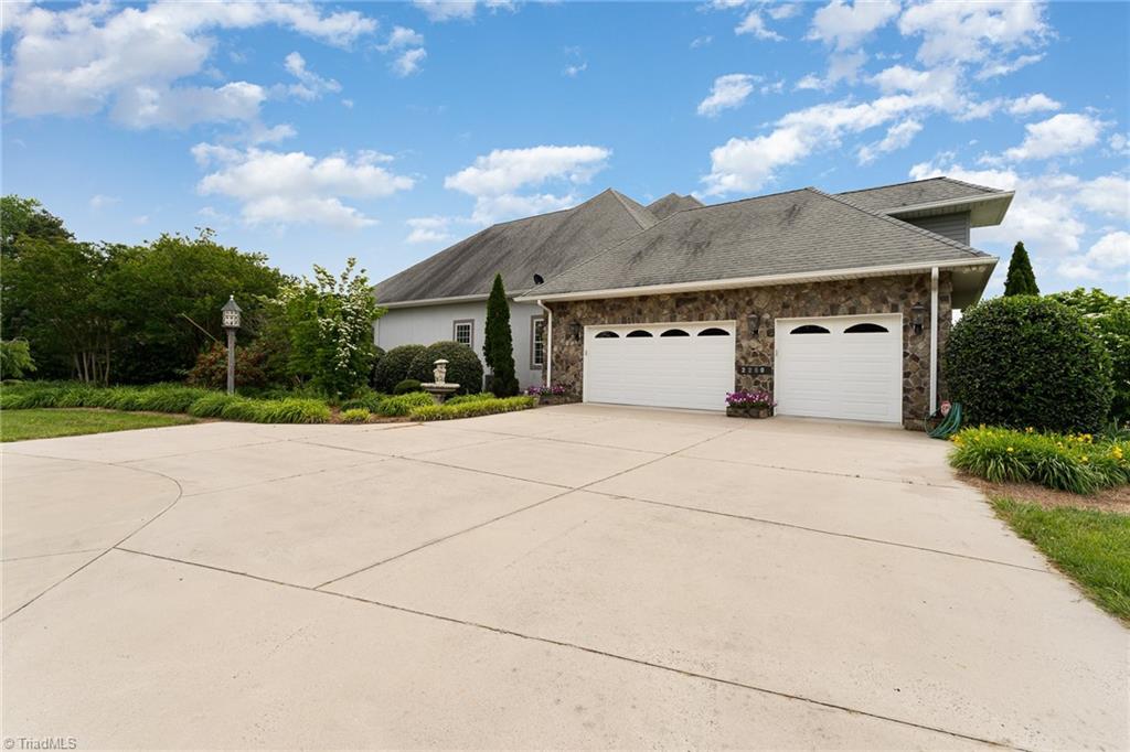 2250 Bethel Church Road Pleasant Garden, NC 27313 - Photo 41 of 45 Spacious 3-car garage complemented by a charming circular paved driveway for easy access and parking.