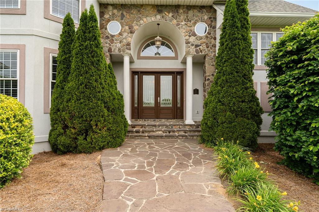 2250 Bethel Church Road Pleasant Garden, NC 27313 - Photo 5 of 45 Grand front entrance welcomes you with an impressive door and beautifully landscaped garden space.