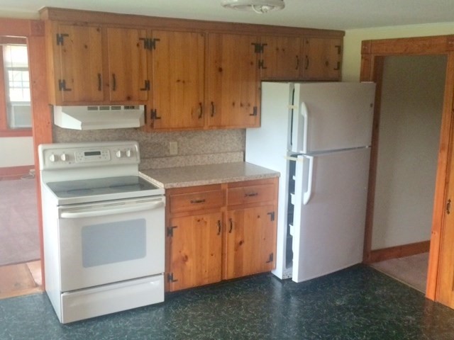 421 North East Street Amherst, MA 01002 - Photo 2 of 7 a kitchen with a stove refrigerator and cabinets