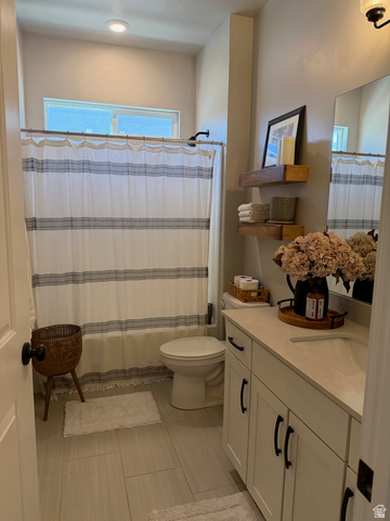315 South Sherman Street Mapleton, UT 84664 - Photo 12 of 30 Bathroom featuring a shower-tub combination with a window, single vanity with shaker-style cabinetry, dark hardware, light countertop, and tile flooring